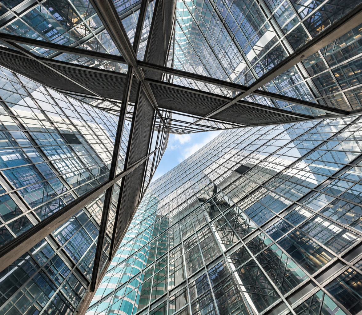 Looking up between glass office towers