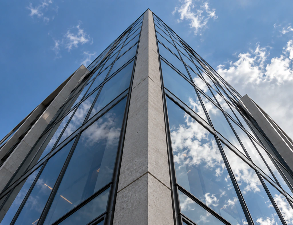 Glass facade of a modern commercial building against the sky