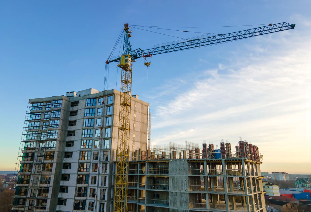 High-rise building under construction with a tower crane