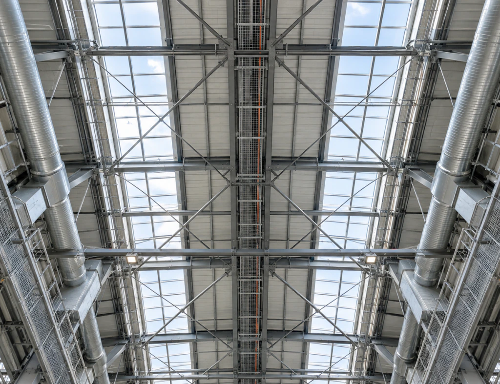 Steel roof trusses and skylights inside a large industrial facility