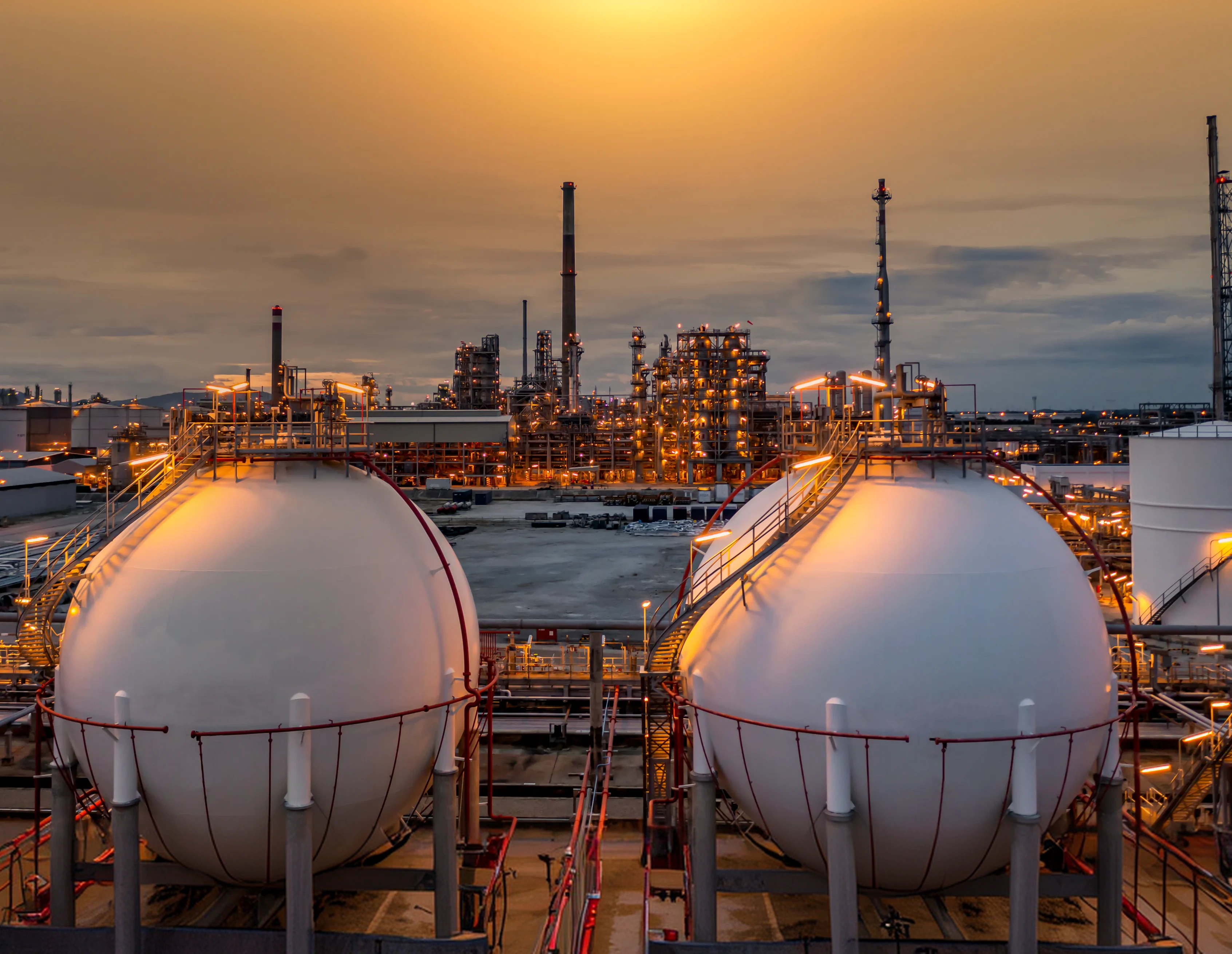 Spherical gas storage tanks at a refinery at sunset