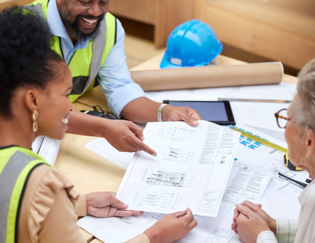 Project managers reviewing drawings on a construction site