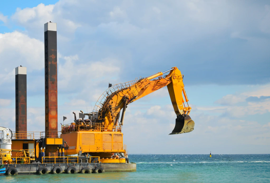 Marine dredging vessel with an excavator